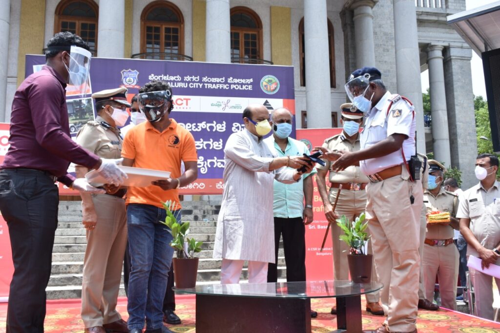 Karnataka Home Minister Basavaraj Bommai Distributes Raincoats to Traffic Police 1
