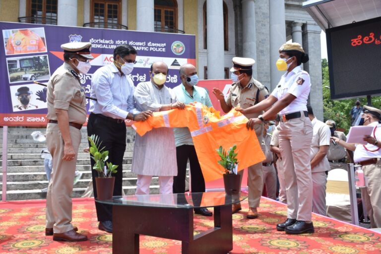 Karnataka Home Minister Basavaraj Bommai Distributes Raincoats to Traffic Police